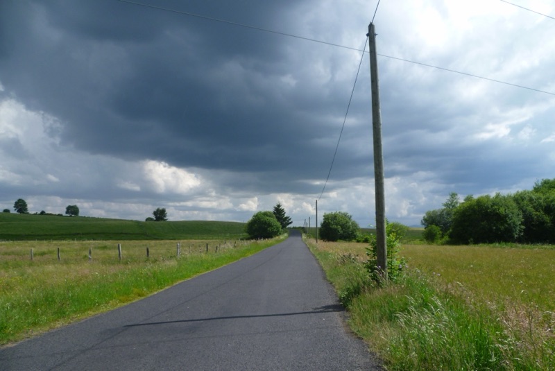 Route de campagne sous un ciel d'orage